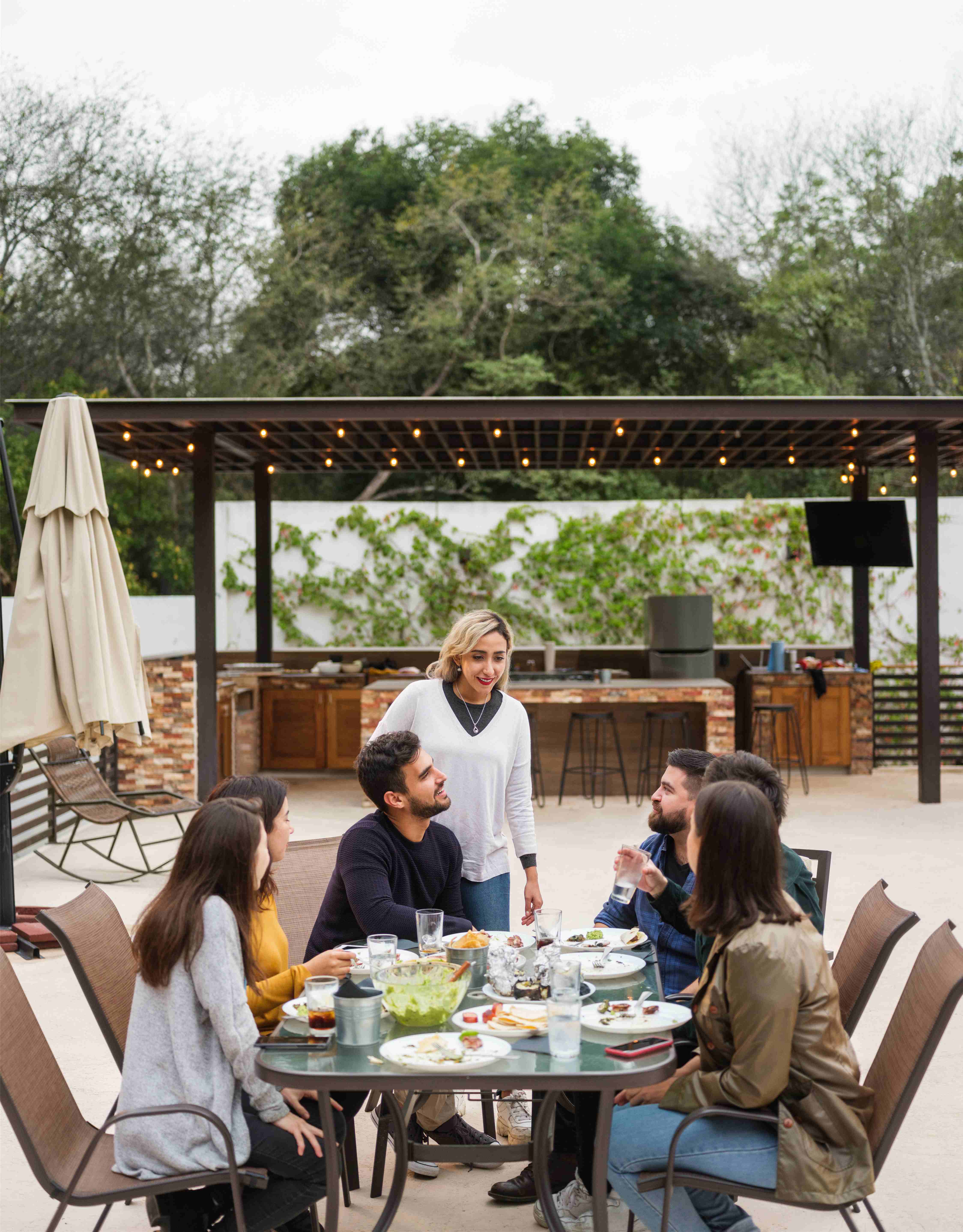 friends having party in front of pergola