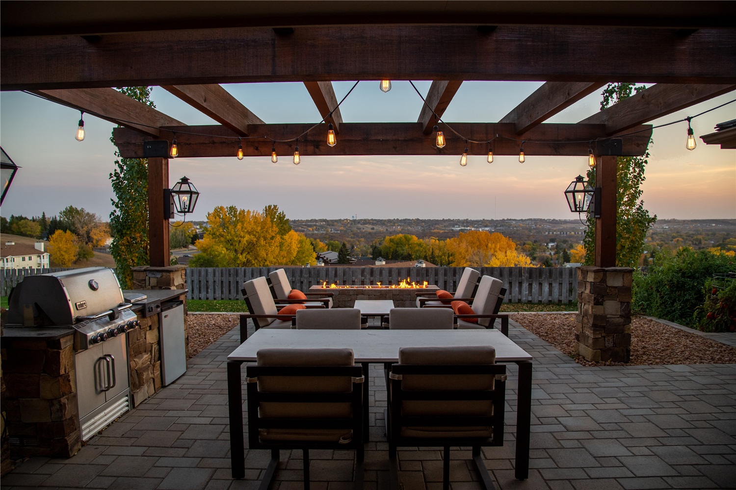 outdoor kitchen under a wooden pergola